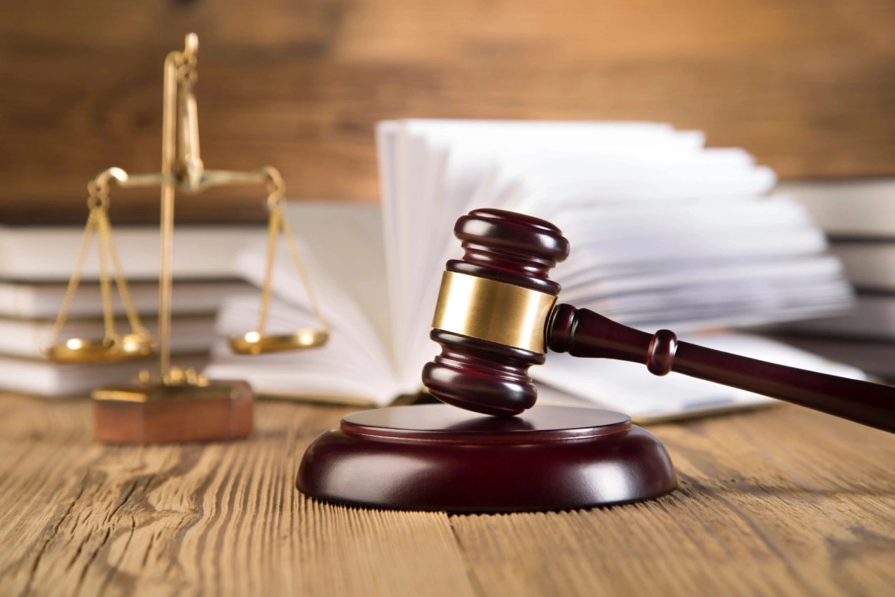 A wooden gavel sitting on top of a table.