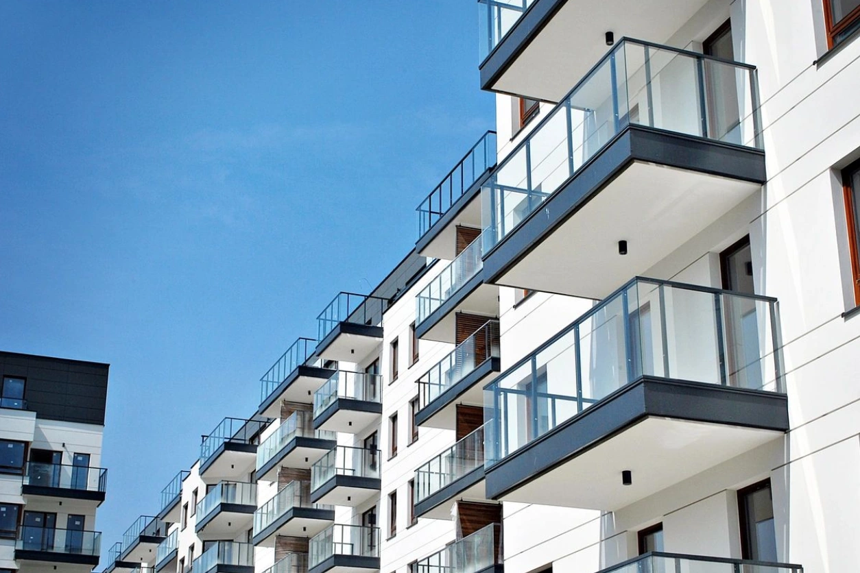 A building with balconies and glass railings.